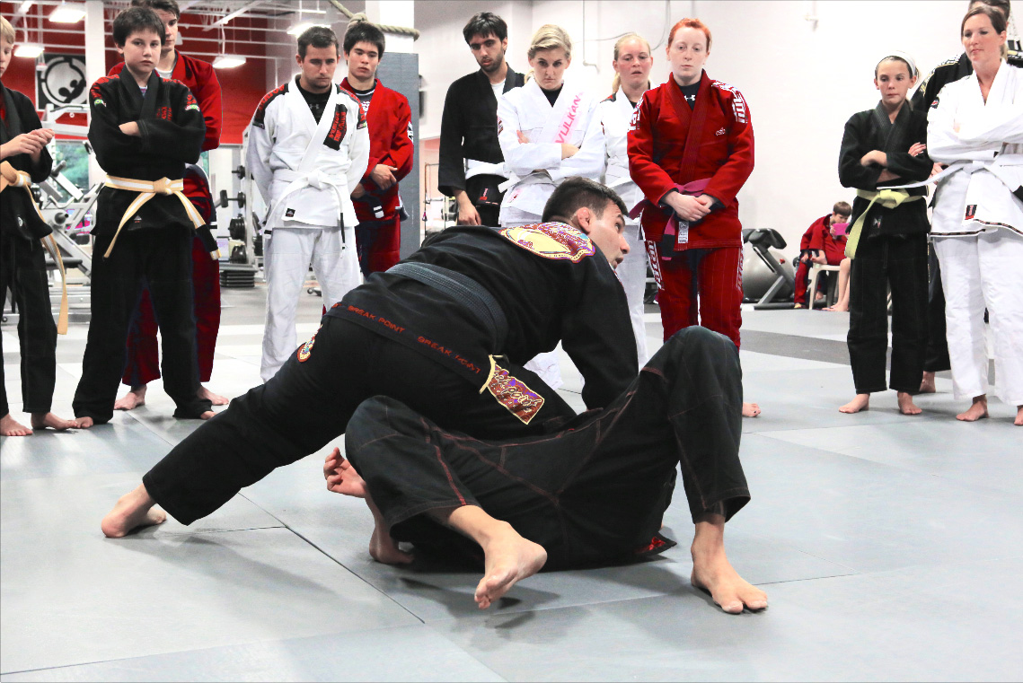 Instructor performing a demo in Brazilian Jiu Jitsu Fundamentals class