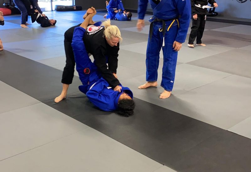 Couples of women and men grappling with each other in a jiu-jitsu class